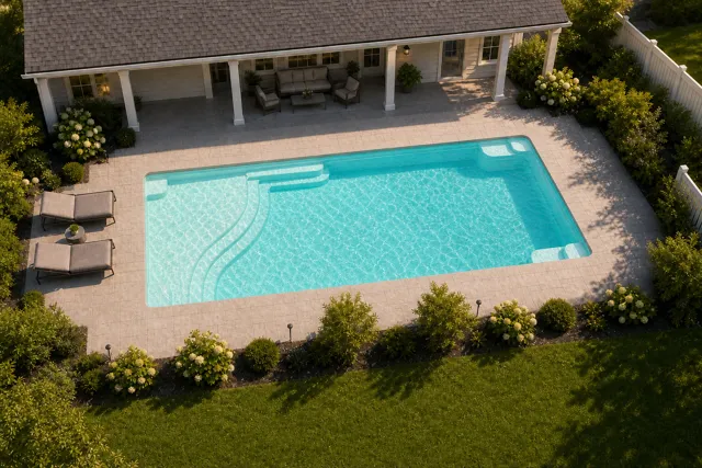 Daytime render of the Aspen 1435 fiberglass pool with cantilever coping and a Arctic Shimmer interior, seen from above at an angle.