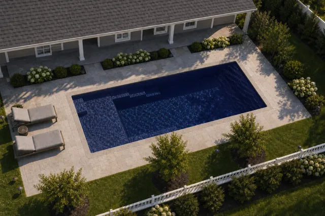 Daytime render of the Enchantment 9.24 fiberglass pool with stone coping and a Night Sky interior, seen from above at an angle.