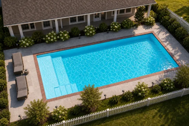 Daytime render of the The Vision 23 fiberglass pool with brick coping and a Coral Blue interior, seen from above at an angle.