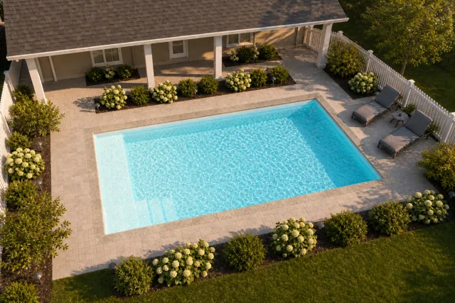 Daytime render of the The Vision 20 fiberglass pool with stone coping and a Ice Silver interior, seen from above at an angle.