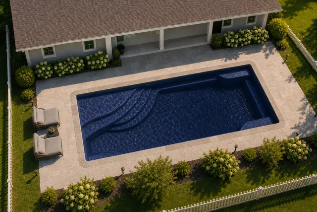 Daytime render of the Olympia 14 fiberglass pool with stone coping and a Night Sky interior, seen from above at an angle.