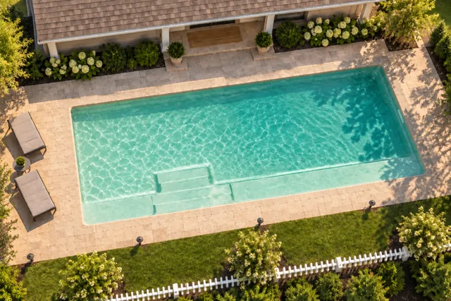 Daytime render of the The Marvelous 35 fiberglass pool with cantilever coping and a Beach Sand interior, seen from above at an angle.