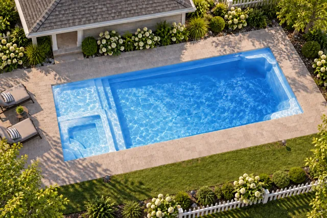 Daytime render of the Astoria 16 fiberglass pool with cantilever coping and a Sapphire Blue interior, seen from above at an angle.