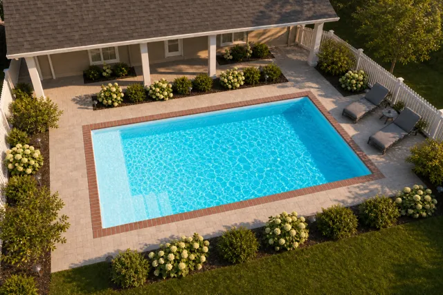 Daytime render of the The Vision 20 fiberglass pool with brick coping and a Coral Blue interior, seen from above at an angle.