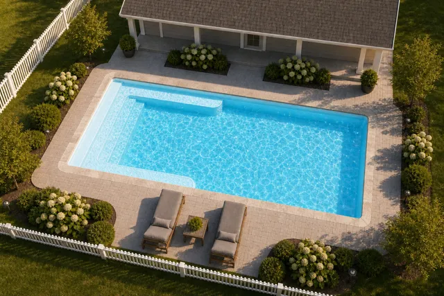 Daytime render of the Lil Bob fiberglass pool with stone coping and a Caribbean Sparkle interior, seen from above at an angle.