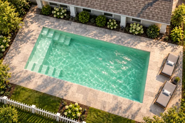 Daytime render of the The Freedom 23 fiberglass pool with cantilever coping and a Beach Sand interior, seen from above at an angle.