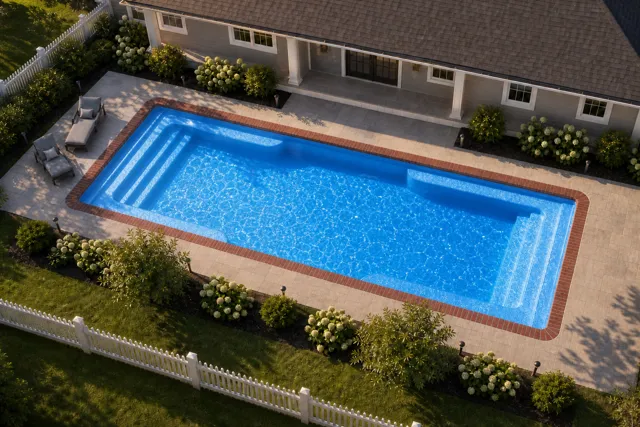 Daytime render of the Spirit fiberglass pool with brick coping and a California interior, seen from above at an angle.