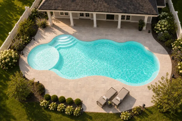 Daytime render of the Wellspring 1640 fiberglass pool with cantilever coping and a Arctic Shimmer interior, seen from above at an angle.