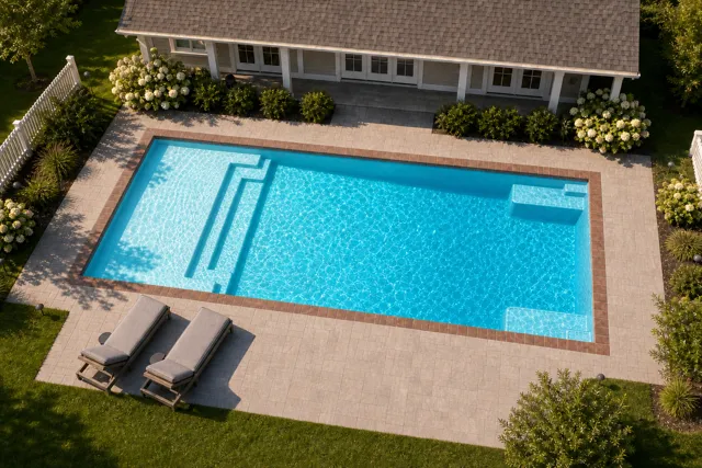 Daytime render of the The Illusion 40 fiberglass pool with brick coping and a Coral Blue interior, seen from above at an angle.