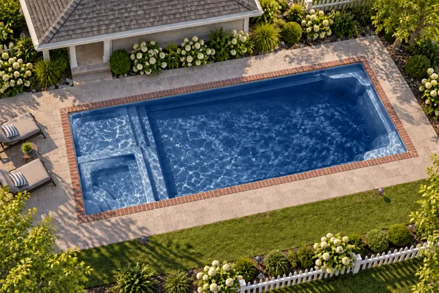 Daytime render of the Astoria 16 fiberglass pool with brick coping and a Ocean Blue interior, seen from above at an angle.