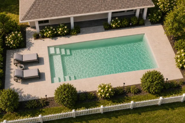 Daytime render of the The Freedom 30 fiberglass pool with cantilever coping and a Beach Sand interior, seen from above at an angle.