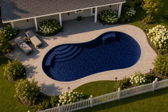 Daytime render of the Jamaica 14 fiberglass pool with stone coping and a Night Sky interior, seen from above at an angle.