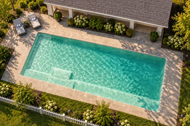 Daytime render of the The Marvelous 40 fiberglass pool with cantilever coping and a Beach Sand interior, seen from above at an angle.