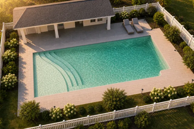Daytime render of the The Bliss 26 fiberglass pool with cantilever coping and a Beach Sand interior, seen from above at an angle.
