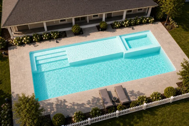 Daytime render of the Mack Daddy fiberglass pool with cantilever coping and a Arctic Shimmer interior, seen from above at an angle.