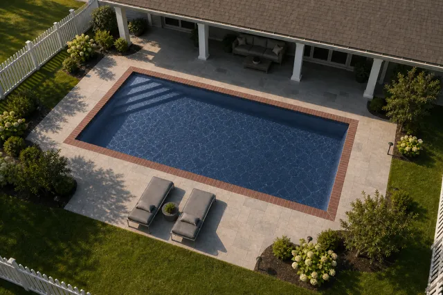 Daytime render of the Delray fiberglass pool with brick coping and a Ocean Blue interior, seen from above at an angle.