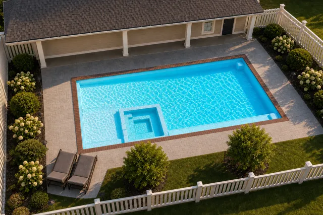 Daytime render of the The Exquisite 35 fiberglass pool with brick coping and a Coral Blue interior, seen from above at an angle.