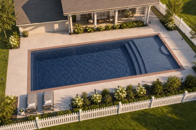 Daytime render of the Cayman 16 fiberglass pool with brick coping and a Ocean Blue interior, seen from above at an angle.