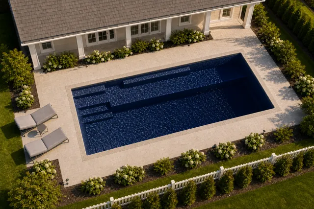 Daytime render of the Providence 14 fiberglass pool with stone coping and a Night Sky interior, seen from above at an angle.