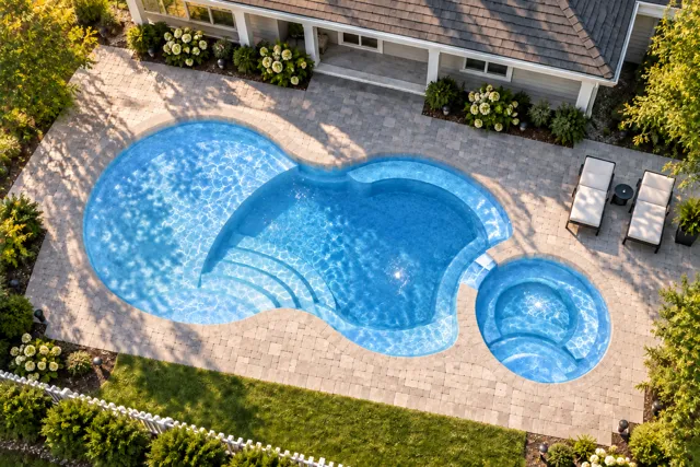 Daytime render of the Axiom 14 Deluxe fiberglass pool with cantilever coping and a Sapphire Blue interior, seen from above at an angle.