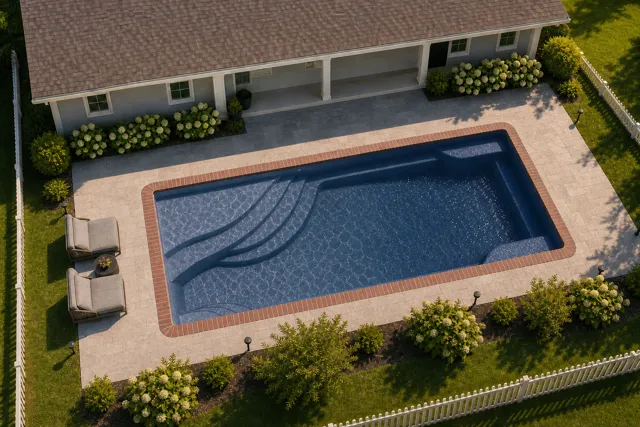 Daytime render of the Olympia 14 fiberglass pool with brick coping and a Ocean Blue interior, seen from above at an angle.