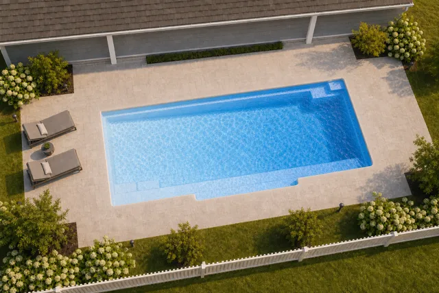 Daytime render of the Tuscan 14.30 fiberglass pool with cantilever coping and a Sapphire Blue interior, seen from above at an angle.